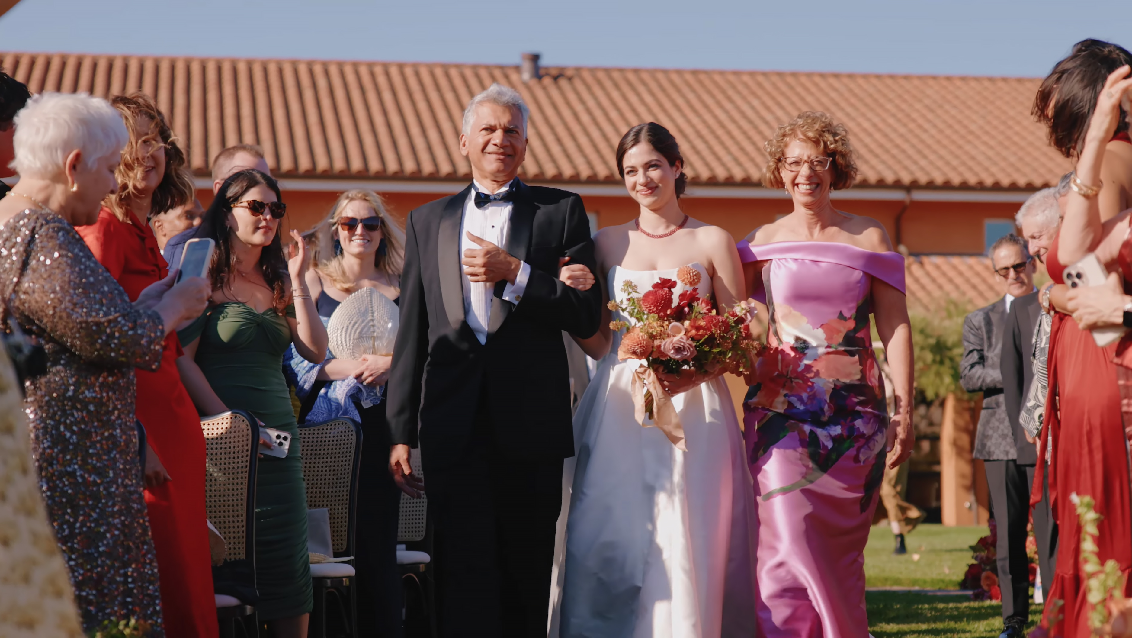 Ryka walking down the aisle with family at Viansa Winery