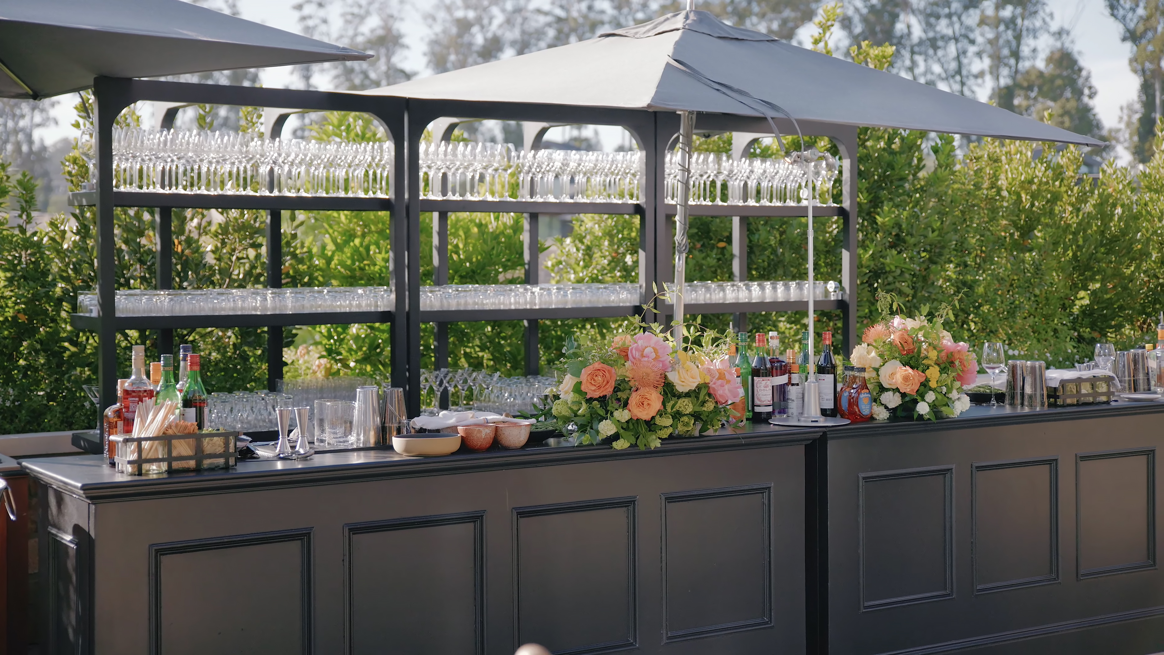 Elegant outdoor bar with floral arrangements at Stanly Ranch