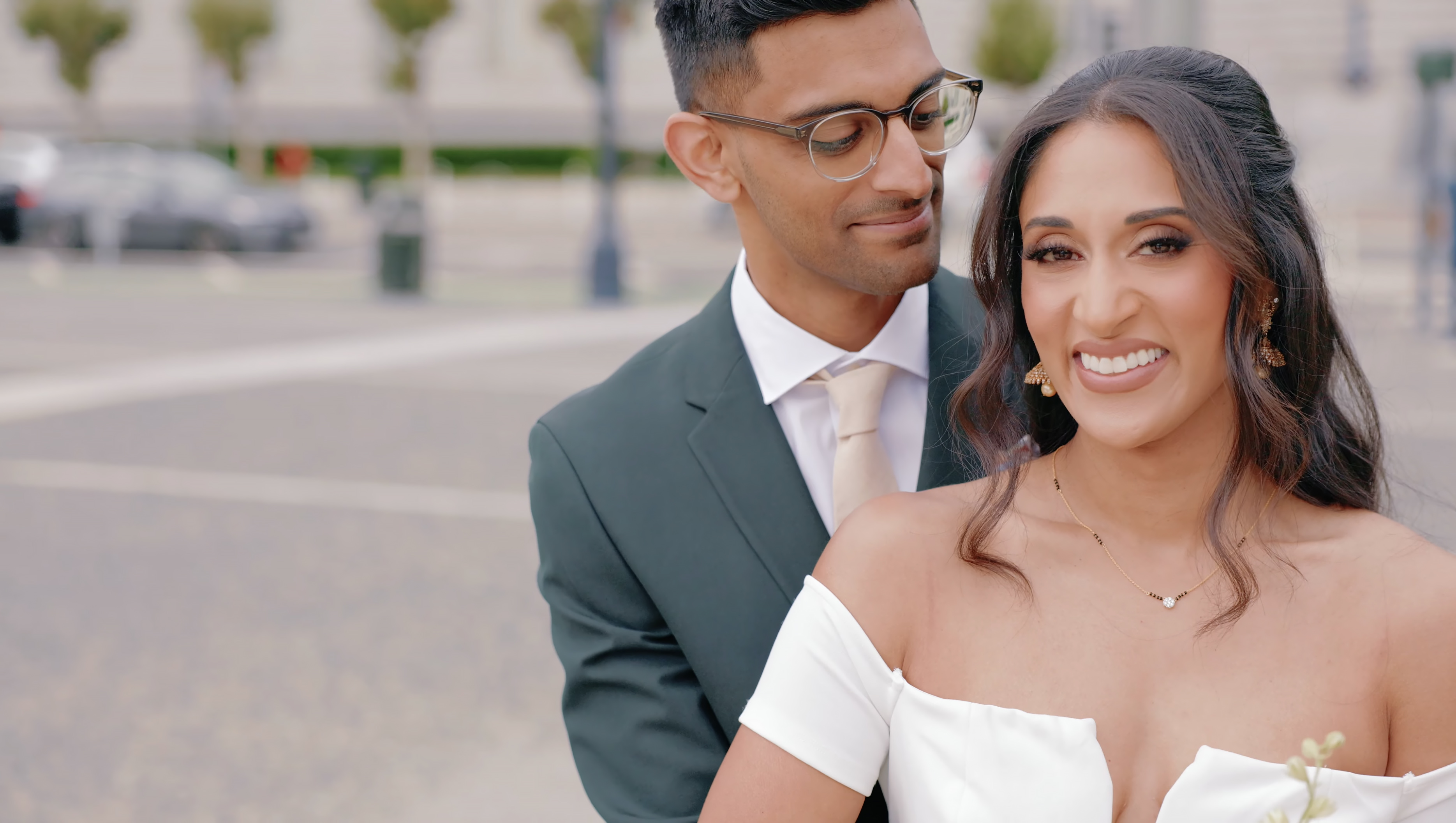 Close portrait of Vini and Jae outside San Francisco City Hall